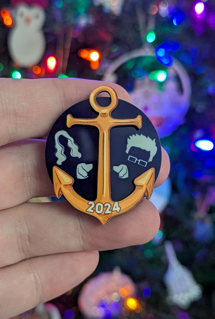 Hand made magnet featuring a golden anchor on a dark blue background.