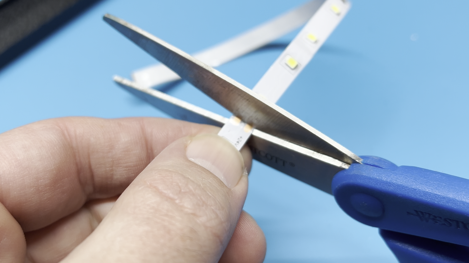 Cutting an LED strip with scissors