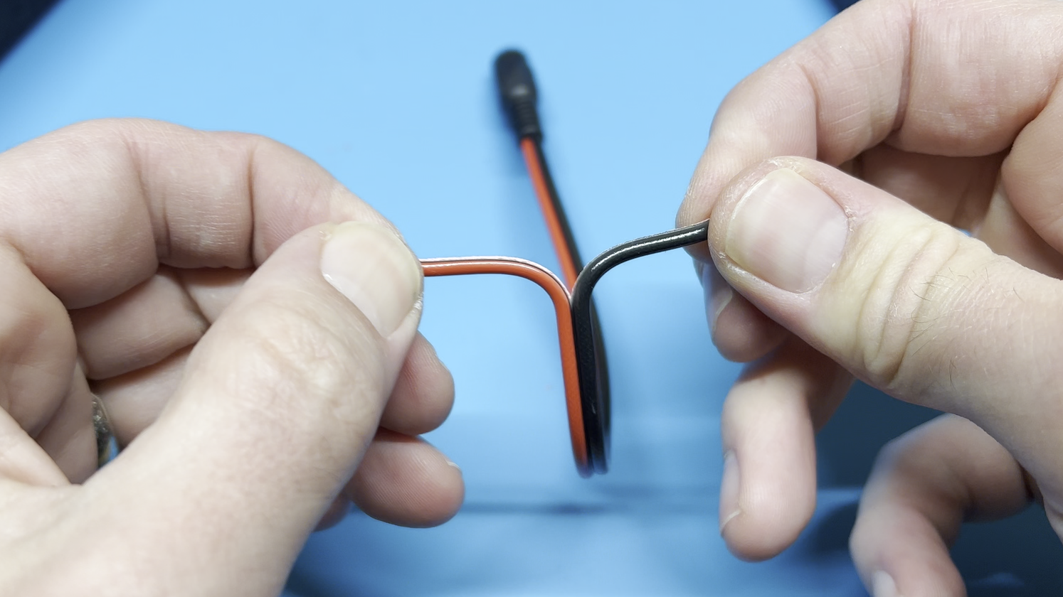 Splitting apart the wires of a barrel jack.